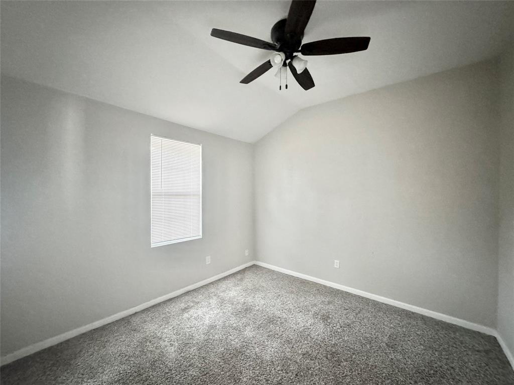314 North Dubellette Street Weatherford, TX 76086 - Photo 10 of 30 an empty room with a window and a fan