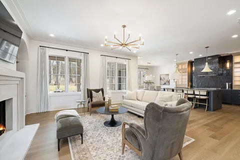 a view of a dining room with furniture and a chandelier