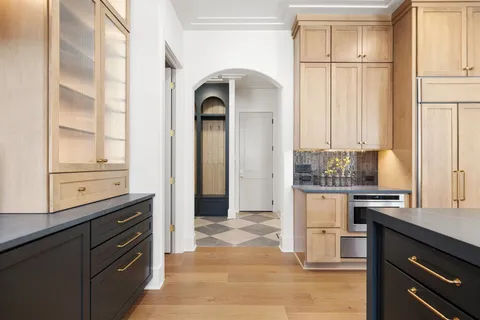 a kitchen with a sink cabinets and window
