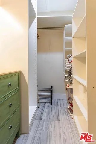 a view of walk in closet with empty racks