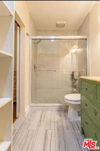 a bathroom with a toilet a sink and shower