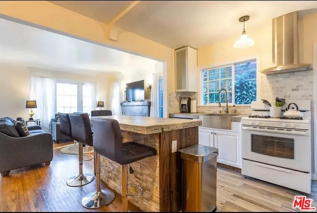 a view of kitchen with sink dining table and chairs
