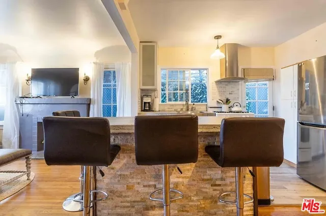 a dining room with furniture and a flat screen tv