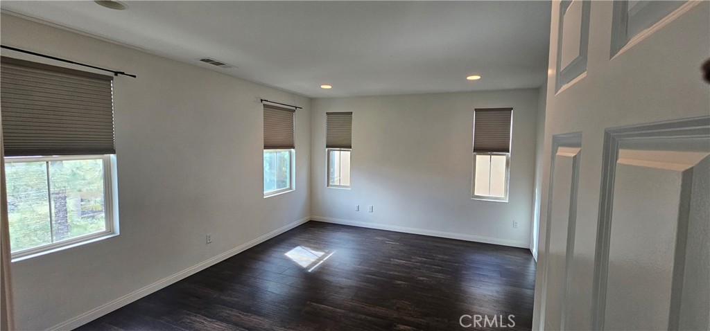 23 Keepsake Irvine, CA 92618 - Photo 11 of 18 an empty room with wooden floor and windows