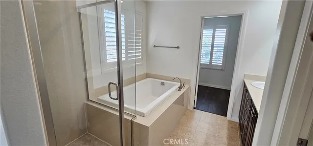 a bathroom with a bathtub next to a window