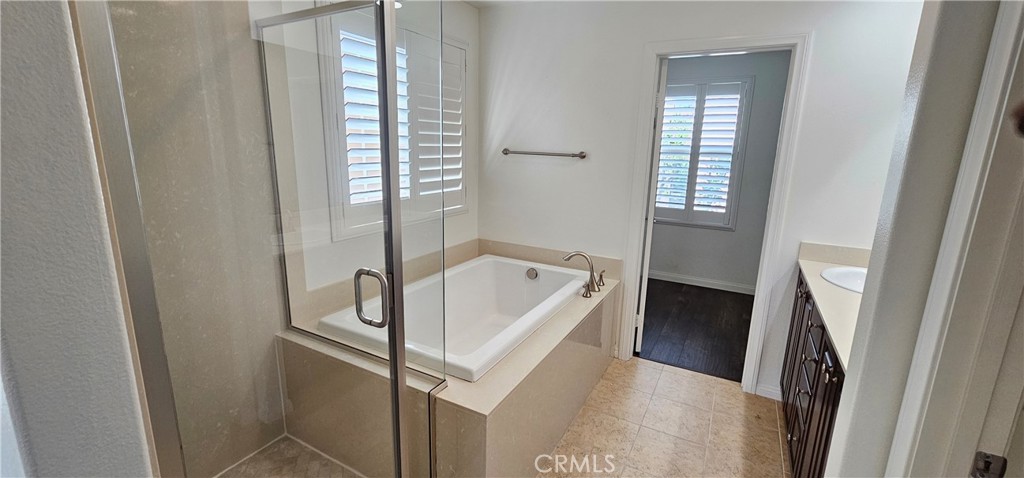 23 Keepsake Irvine, CA 92618 - Photo 12 of 18 a bathroom with a bathtub next to a window