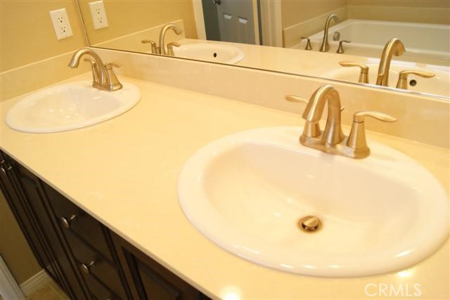 23 Keepsake Irvine, CA 92618 - Photo 15 of 18 a bathroom with a sink and a mirror