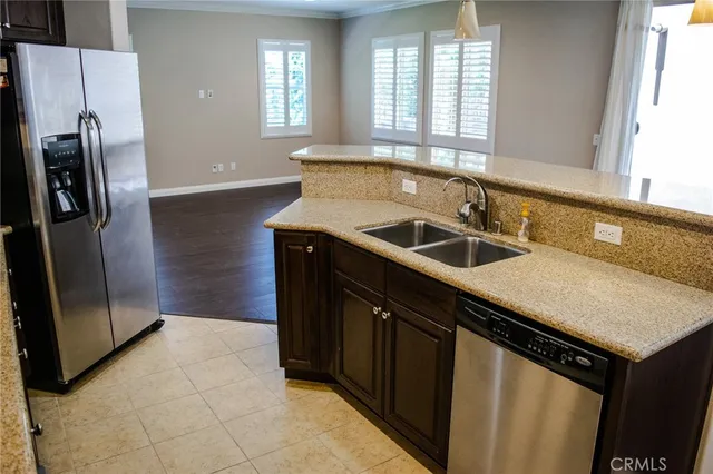 a kitchen with a sink a counter top space and stainless steel appliances