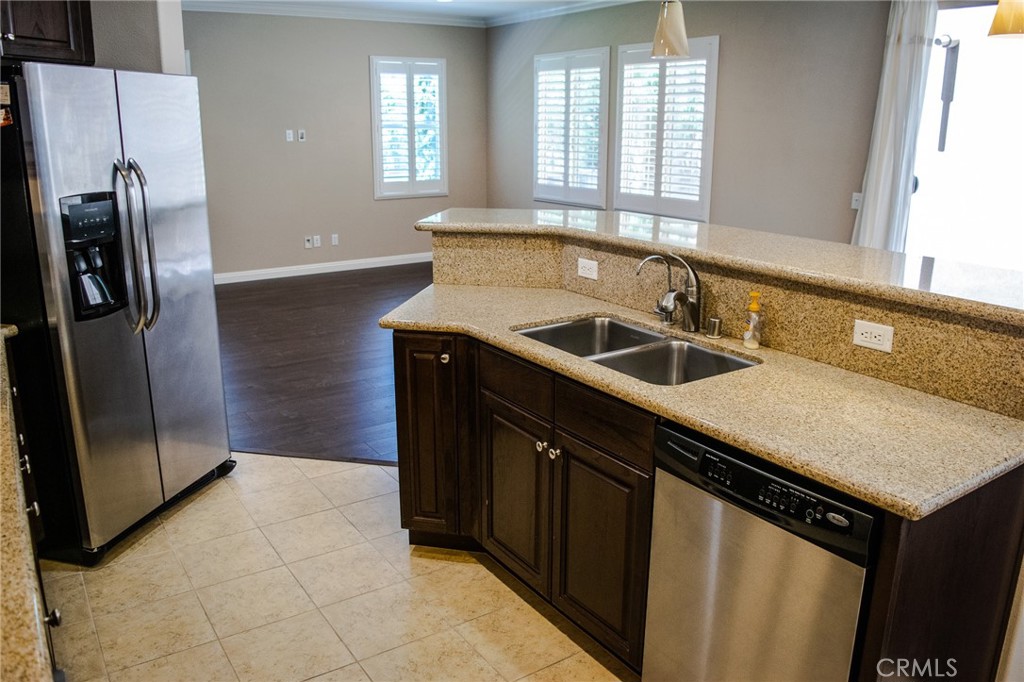 23 Keepsake Irvine, CA 92618 - Photo 5 of 18 a kitchen with a sink a counter top space and stainless steel appliances