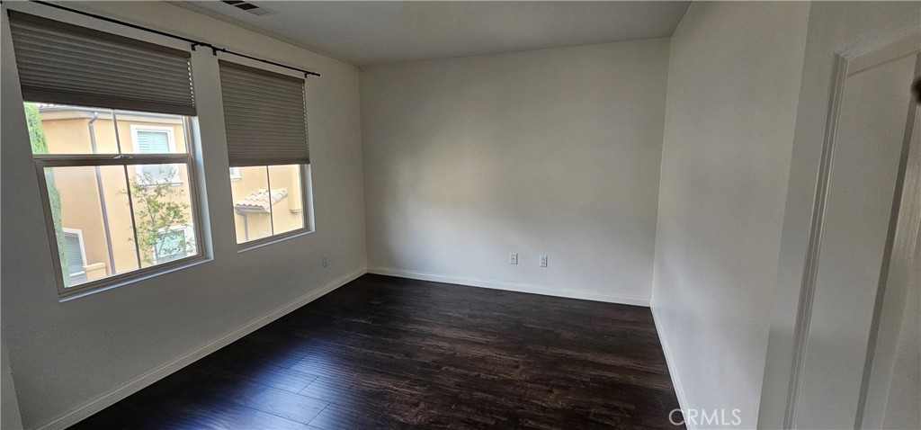 23 Keepsake Irvine, CA 92618 - Photo 9 of 18 an empty room with wooden floor and windows