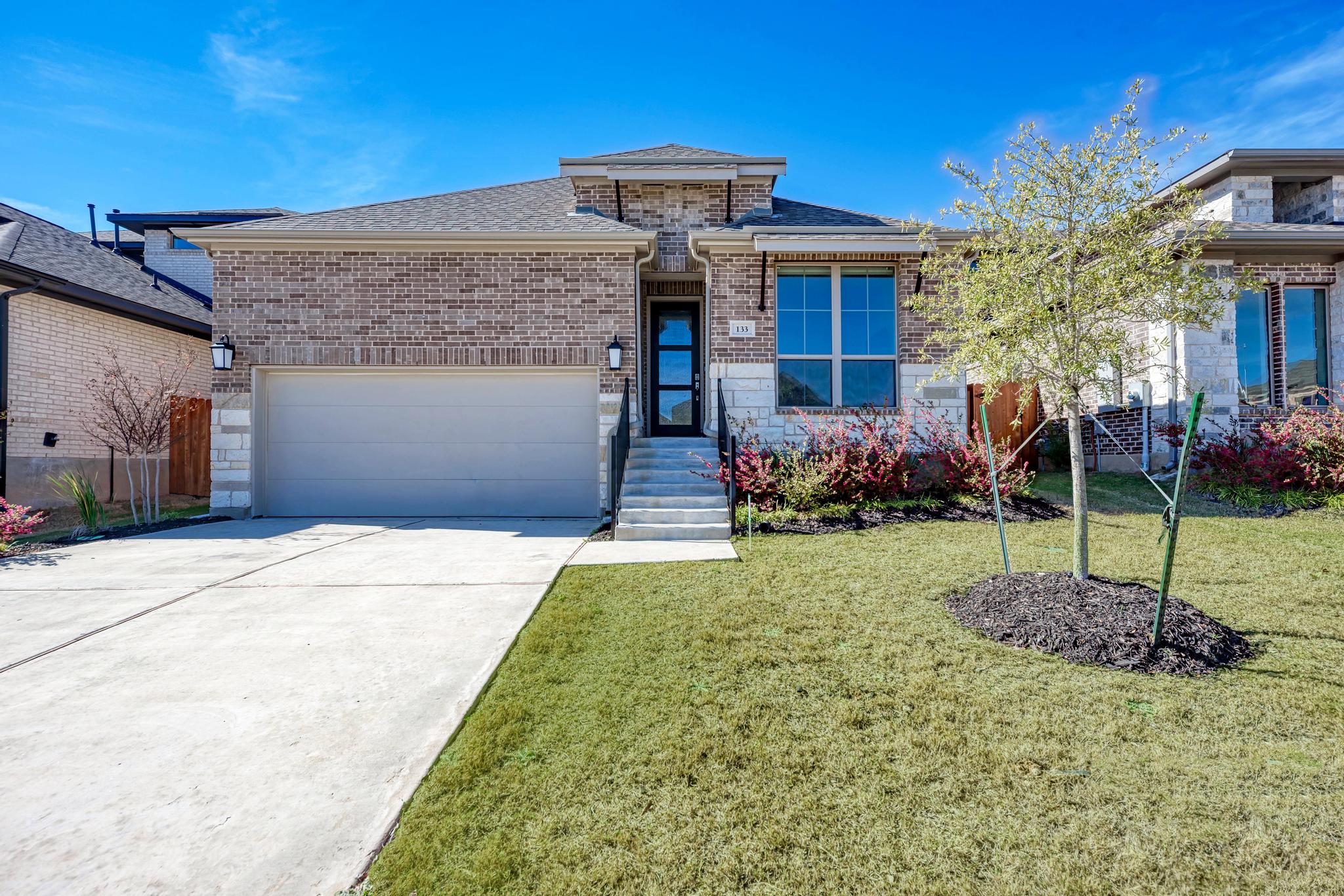a front view of a house with garden