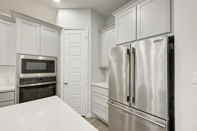 a kitchen with a sink and a refrigerator