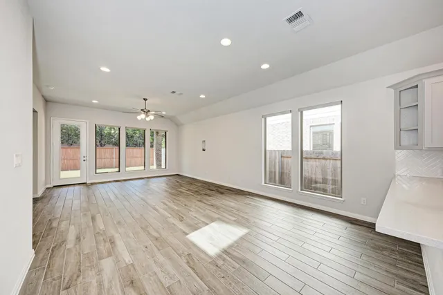 a kitchen with stainless steel appliances white cabinets and a refrigerator