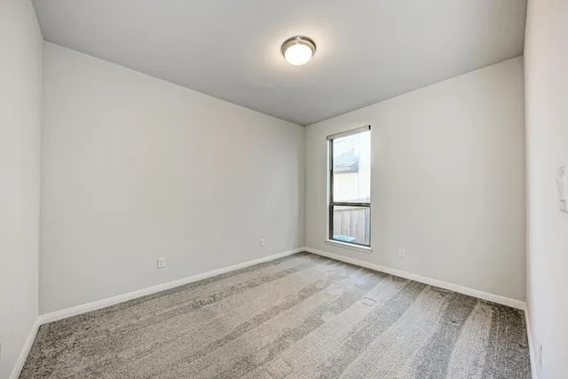 a view of kitchen and hall with wooden floor