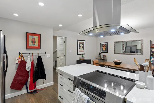 a living room with lots of furniture and air hockey table