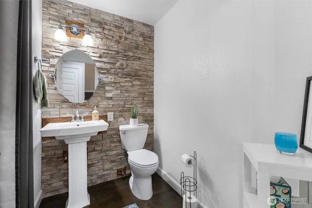 a bathroom with a toilet sink and mirror