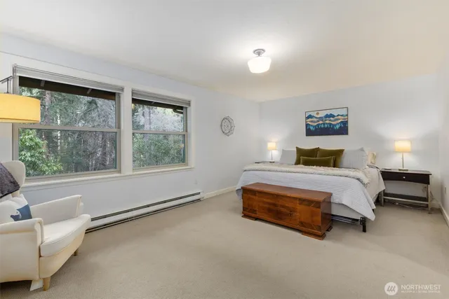 a bedroom with a bed and a large window