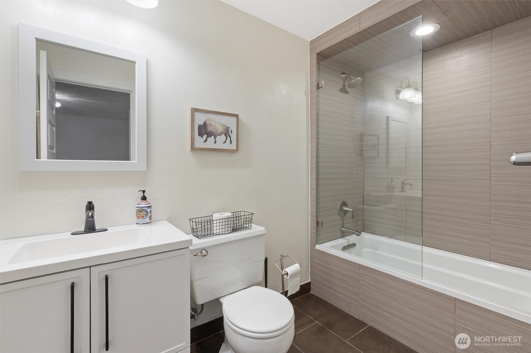 8515 Main Street, Unit 103 Edmonds, WA 98026 - Photo 23 of 34 a bathroom with a sink a toilet and shower