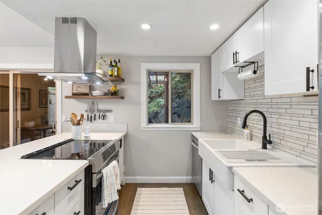 a kitchen with a sink cabinets and window