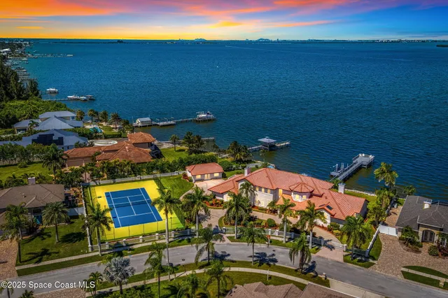 an aerial view of a house with a swimming pool yard and outdoor seating