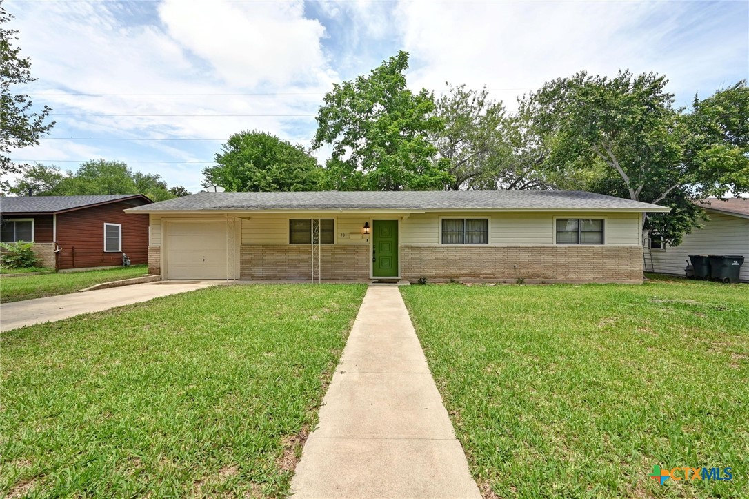 201 Hillcrest Drive Luling, TX 78648 - Photo 1 of 26 a view of house with a yard and potted plants