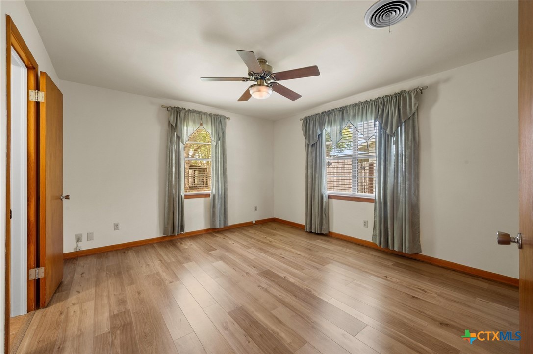 201 Hillcrest Drive Luling, TX 78648 - Photo 13 of 26 wooden floor in an empty room with a window