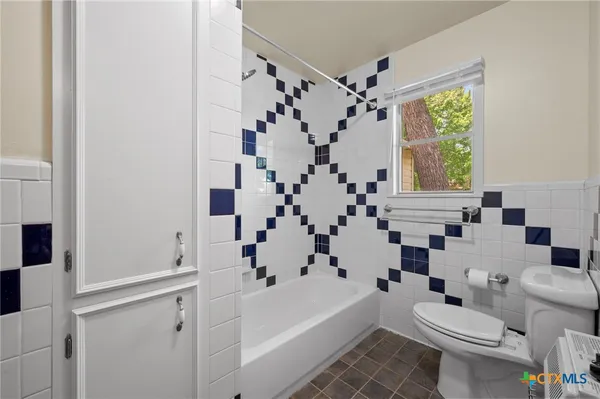 a bathroom with a bathtub a sink and a shower curtain