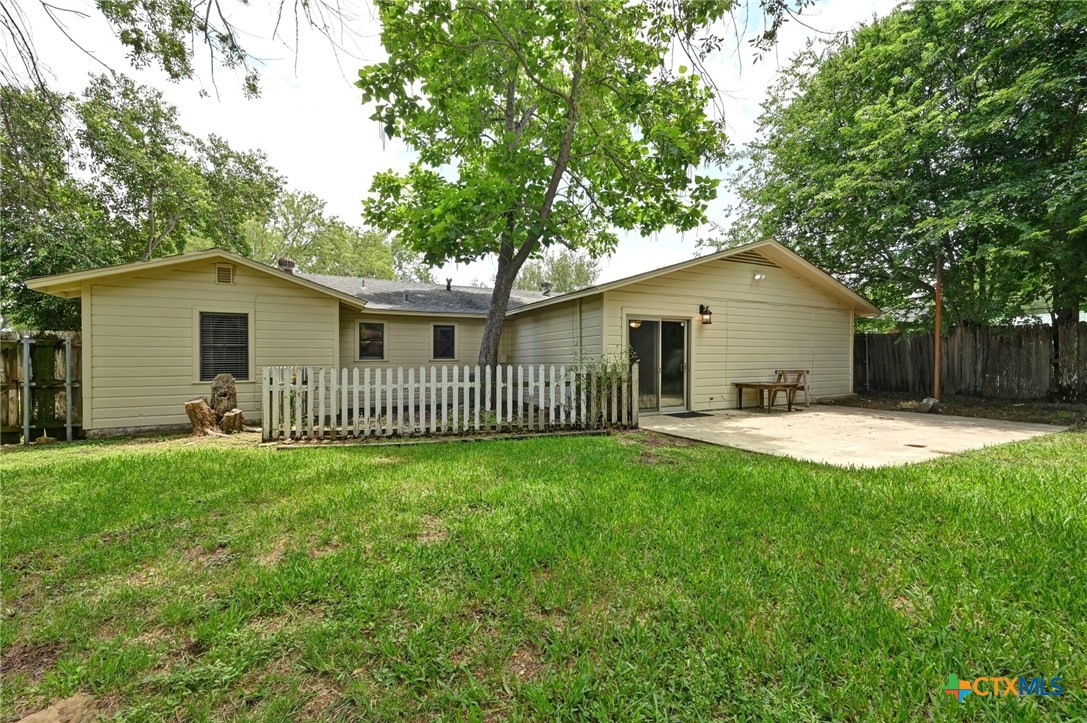 201 Hillcrest Drive Luling, TX 78648 - Photo 23 of 26 a view of a house with a yard and a garden