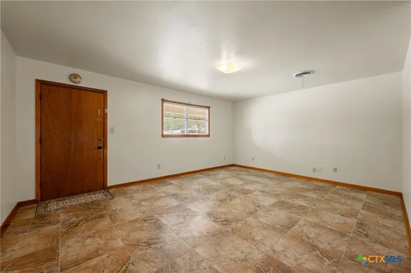 an empty room with a windows