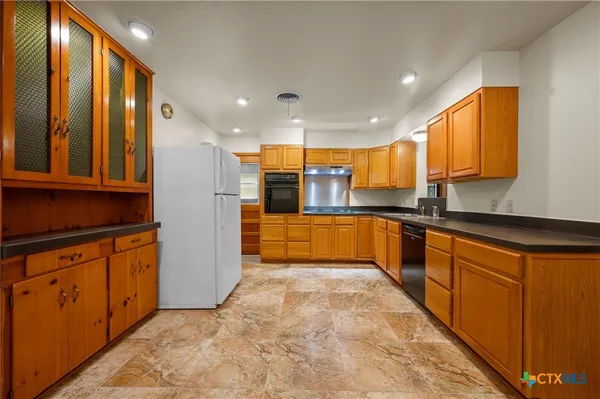 a large kitchen with stainless steel appliances granite countertop a large counter top stainless steel appliances and cabinets