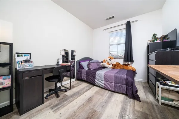 a bedroom with a bed and a desk