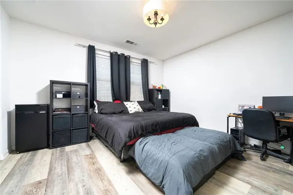 a bedroom with a bed and a mirror