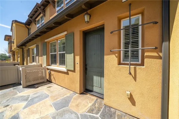 a view of a house with a door and a car parked