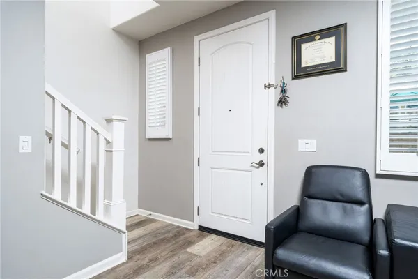 a large white kitchen with stainless steel appliances kitchen island granite countertop a refrigerator stove top oven and couches
