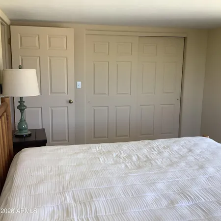 a bedroom with a bed and a lamp