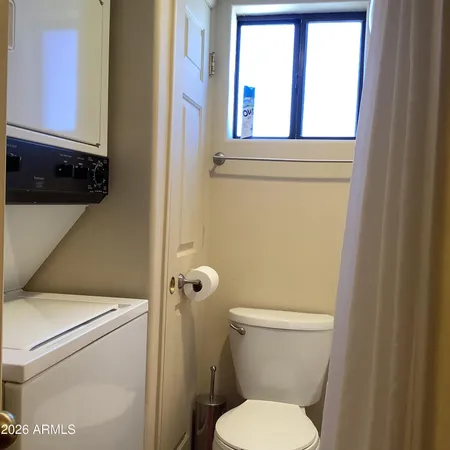 a white toilet sitting next to a window