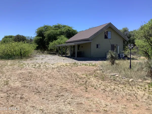 a view of house with wooden fence