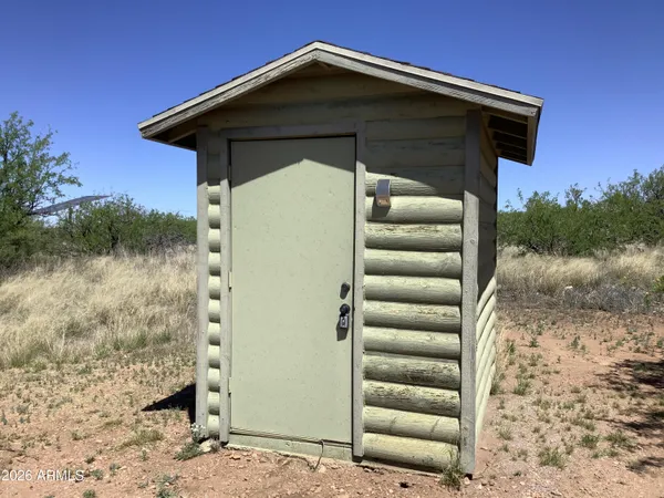 a view of a wooden door and a yard