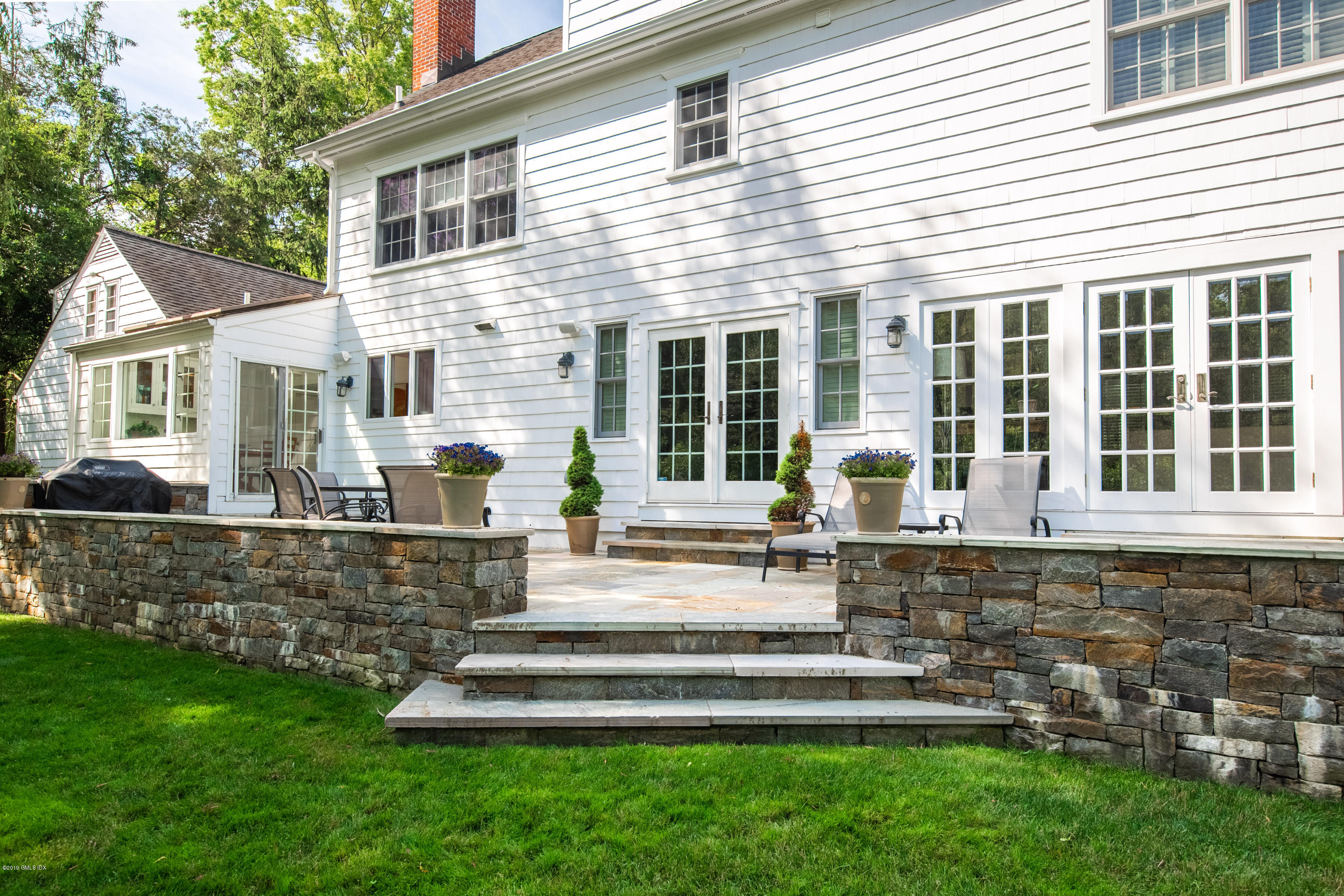 8 Plow Lane Greenwich, CT 06830 - Photo 19 of 24 a front view of a house with a yard