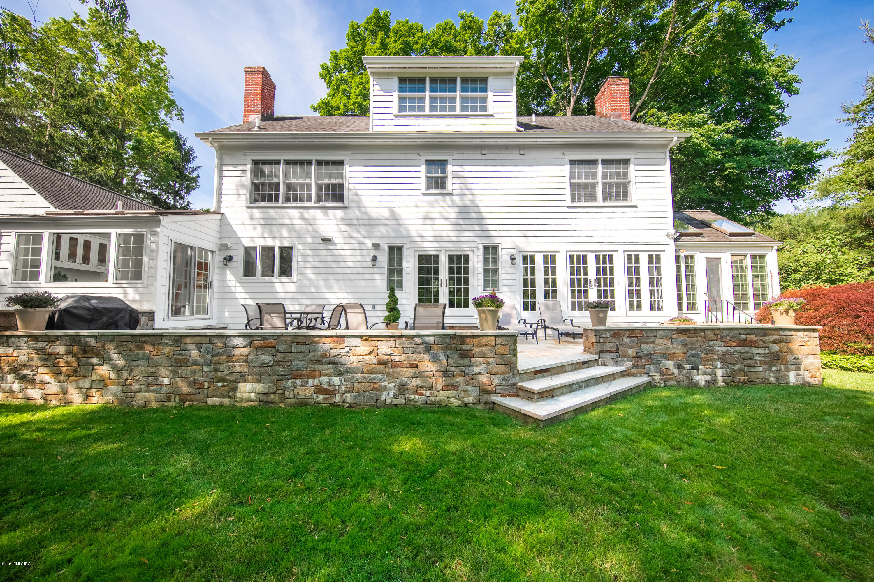 8 Plow Lane Greenwich, CT 06830 - Photo 20 of 24 front view of a house with a yard