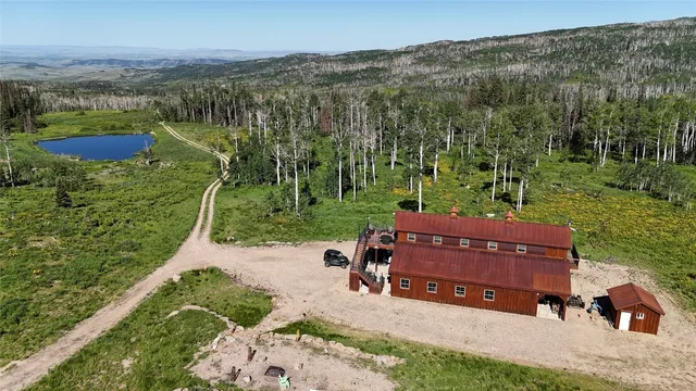 an aerial view of a house with a yard