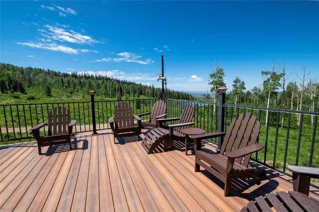 a view of a chairs and table on the wooden deck