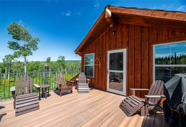 a patio with wooden floors and lake view