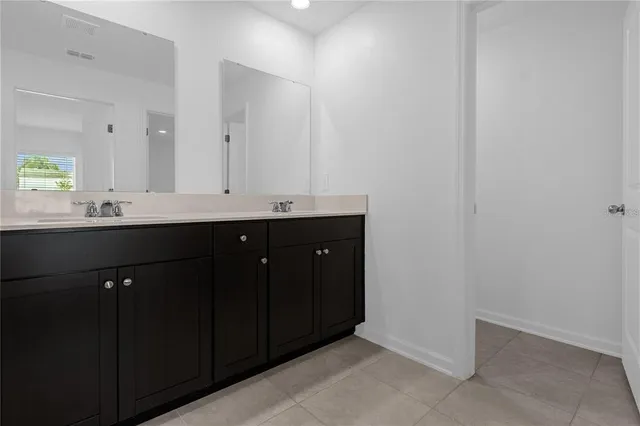 a kitchen with a sink and a mirror