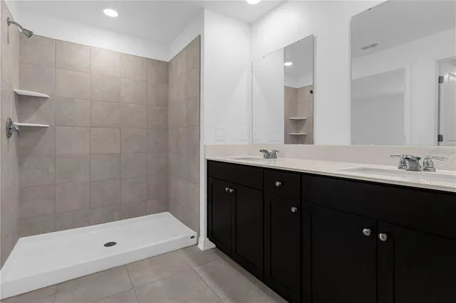 a bathroom with a double vanity sink and mirror