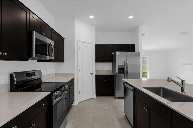 a kitchen with a sink microwave and refrigerator