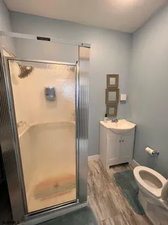 a bathroom with a sink toilet and shower