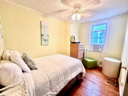 a bedroom with a bed dresser and a window