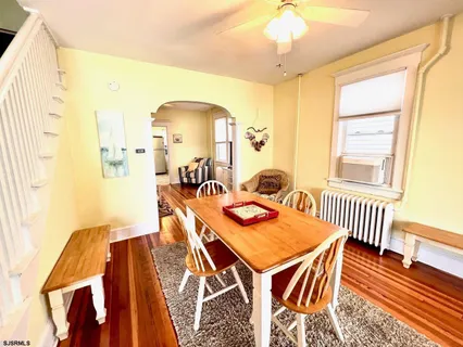 a view of a dining room with furniture and wooden floor