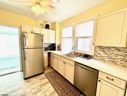 a kitchen with a refrigerator and a sink